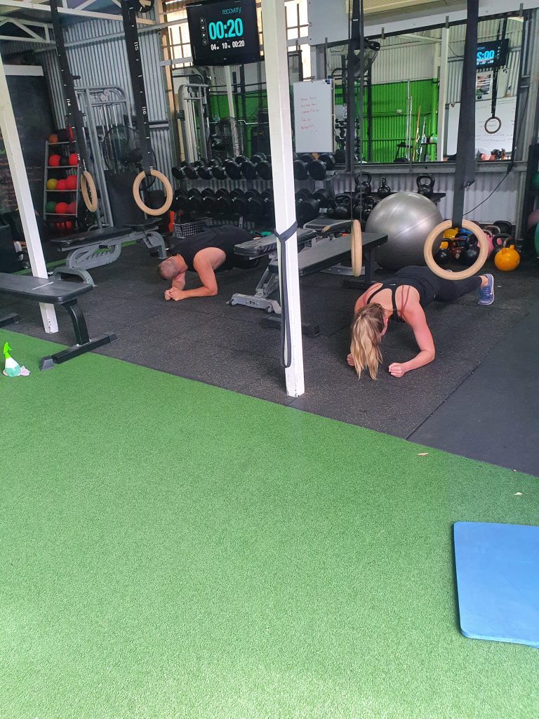 core training, 2 people doing a plank core exercise